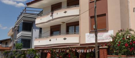 A two-story building with a sign reading "Ephorus Palace".