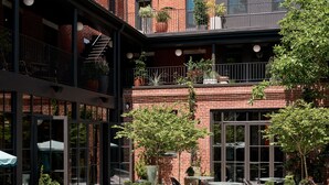 A courtyard with a swimming pool, outdoor seating, and potted plants. - Hotel Anna & Bel (Philadelphia)