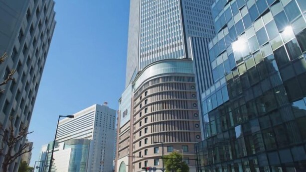 A modern high-rise building with a curved facade, large windows, and a clear sky. - Hotel Balian Resort Namba Shinsaibashi - Near Dotonbori (Osaka)