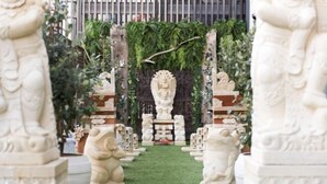 A pathway flanked by stone lion statues leading to a central altar with a statue, surrounded by greenery and a stone wall. - Hotel Balian Resort Namba Shinsaibashi - Near Dotonbori (Osaka)