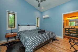 A bedroom with a bed, a nightstand, a dresser, and a window. - Mtn Retreat, River Access, Fire Pit, WiFi, Grill! (Spruce Pine)