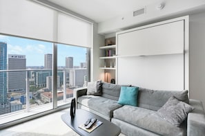Deluxe Condo, 1 Bedroom, City View | Living area | 50-inch plasma TV with cable channels