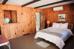 A wooden-paneled room with a bed, a desk, and a globe. - Room 6 • Retro Desert Escape  - Joshua Tree (Joshua Tree)