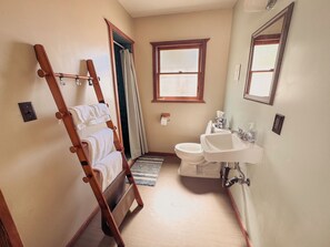 A bathroom with a wooden ladder, a toilet, a sink, and a window. - Room 6 • Retro Desert Escape  - Joshua Tree (Joshua Tree)