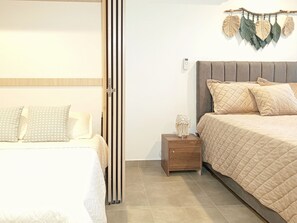 A bedroom with a bed, nightstand, and wall-mounted decor. - salguero suite 313 (Santa Marta)