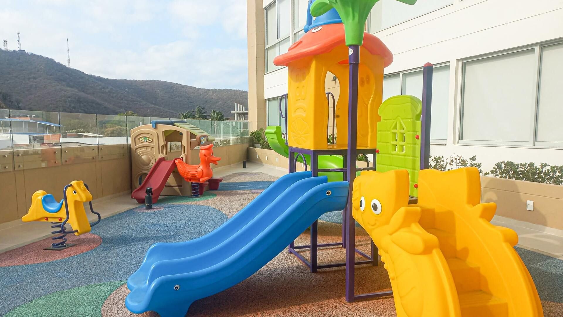 A children's play area with slides and climbing structures.