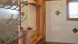 A bathroom with wooden cabinetry, a sink with a mirror, and a window providing natural light. - Beautiful home in Mariapfarr with WiFi (Mariapfarr)