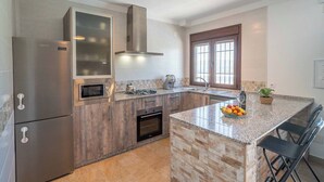 A modern kitchen with a built-in oven, a microwave, and a stainless steel refrigerator. - Villa Madrid Alcazar El Gastor by Ruralidays (Cádiz)