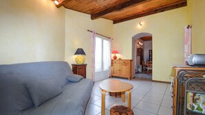 A cozy living room with a sofa, a small wooden table, and a cabinet. - 2 bedroom gorgeous apartment in Poggio Di Nazza (Poggio Di Nazza)