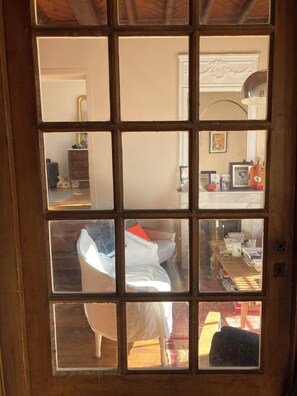 Step into a classic retreat with a comfortable bed, a small table, and a cozy reading nook.