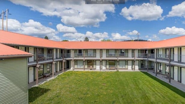 A modern building with a central courtyard, multiple balconies, and a flat roof. - Hotel Viewmont Residency Ltd. (Logan Lake)