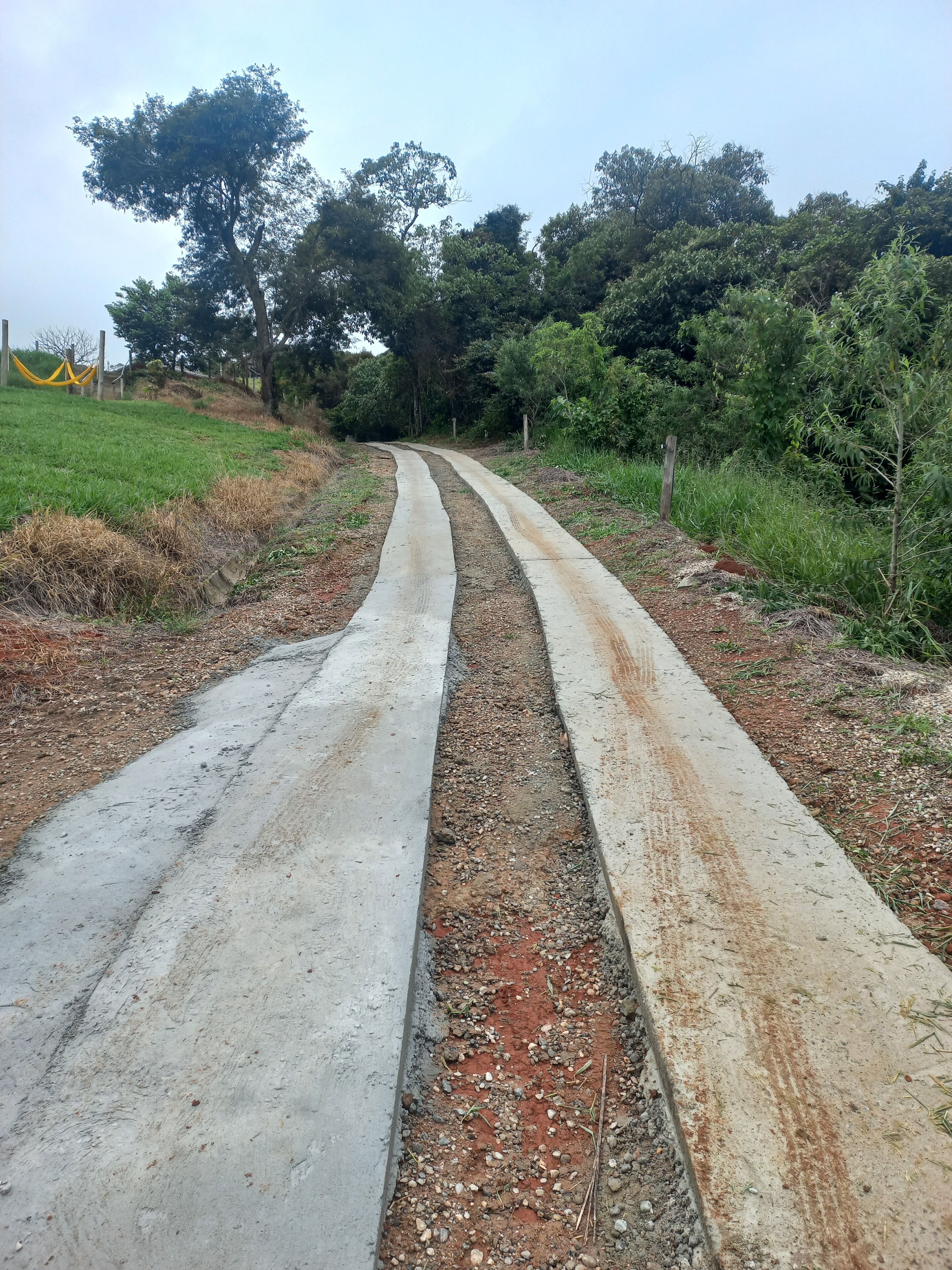A rural road with a concrete divider.