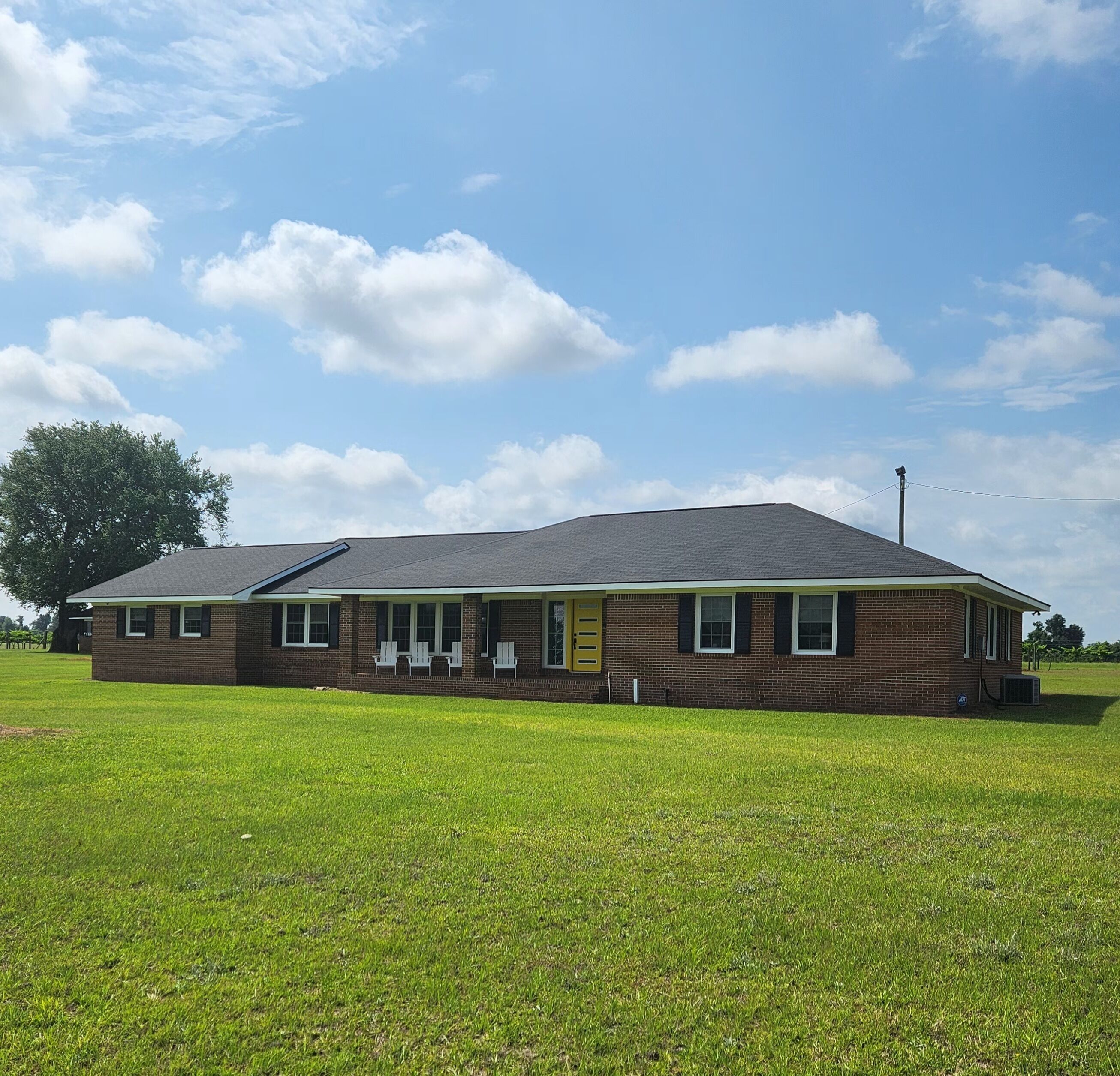 Front of property with four Adirondack chairs, cushions in laundry room.