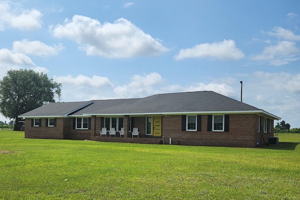 Front of property with four Adirondack chairs, cushions in laundry room.