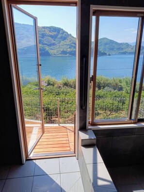 A balcony with a view of a lake and mountains. - nagi-setouchi (Kure)