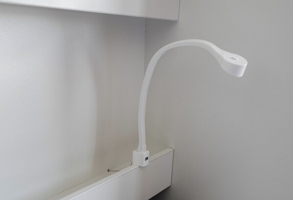 A white wall-mounted light fixture with a USB port.