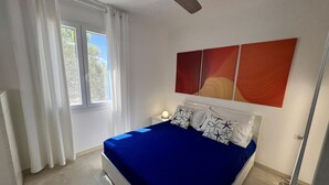 A bedroom with a bed, white curtains, a ceiling fan, and a window with white curtains. - TSG 4 (Apartment + Extra Overview Terrace) (Ugento)