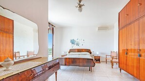 A bedroom with a large bed, wooden wardrobe, dresser, and a large mirror. - Villa Mattalia Relax at Villa for 10, Manduria, Italy (Manduria)