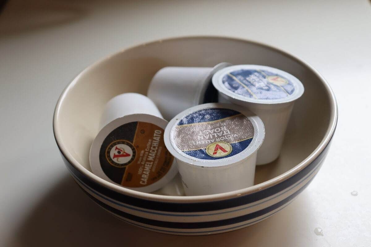 A bowl containing three coffee pods.