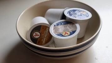 A bowl containing three coffee pods.