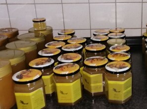 Multiple jars of honey on a kitchen counter.