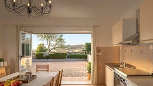 A kitchen with a view of a paved patio and a tree. - Villa Rosy Comfortable Holiday Residence (Rovinj)
