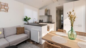 A modern apartment with a kitchen, dining area, and living room. - Chalet in Middelkerke Near the Beach (Middelkerke)