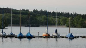 A marina with several sailboats docked, surrounded by a forested area. - Holiday Apartment Siuerlanner (Sundern)
