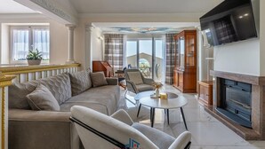 A spacious living room with a large sofa, a coffee table, and a fireplace. - Donatella -apt 2- met Zeezicht (Medulin)