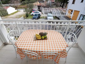 Enjoy a meal on the balcony with a view of the surrounding neighborhood.