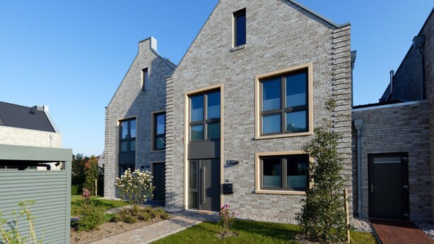 A modern two-story house with a brick exterior, large windows, and a well-maintained garden. - Holiday Home Traumstuuv (Varel)