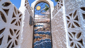 A narrow passageway with a decorative glass door featuring a seascape design. - Belvilla by OYO Holiday Home in Arico El Nuevo (Arico)