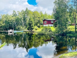 A house by a lake with a dock and a boat. - 2 Person Holiday Home in Nodinge (Nodinge-Nol)