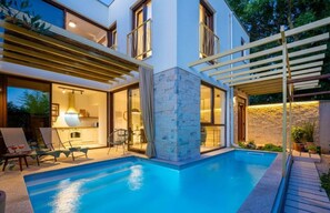 A modern house with a swimming pool, outdoor seating, and a covered patio area. - Verborgen Villa (Vodnjan)