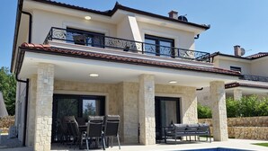 A two-story house with a swimming pool, stone pillars, and outdoor seating. - Apartment in Croatia Near the Adriatic Coast (Malinska-Dubasnica)
