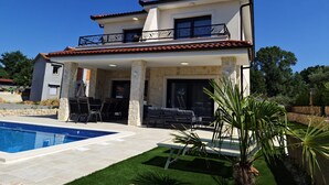 A two-story house with a swimming pool, outdoor seating, and a balcony. - Apartment in Croatia Near the Adriatic Coast (Malinska-Dubasnica)