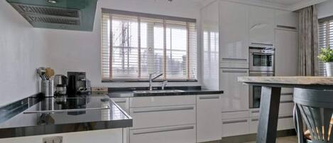 Villa | Private kitchen | Fridge, electric kettle, highchair