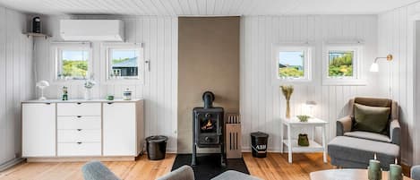 A cozy room with a fireplace, a dining table, and a comfortable seating area.