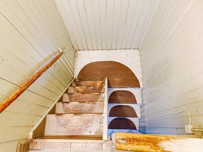 A narrow staircase with wooden steps and white walls. - 4 Person Holiday Home in Bjorko (Björkö)