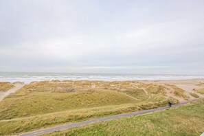 Guests can walk along the paved pathway to the beach with its sand dunes and grassy areas.