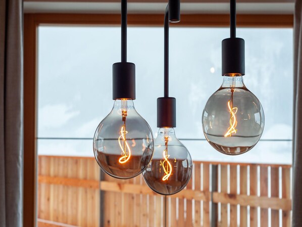 Three hanging light bulbs with visible filament designs.