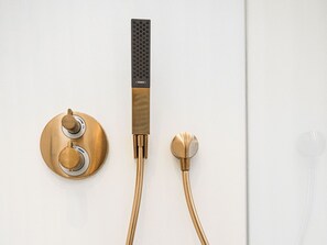 A modern shower with a round control knob, a vertical handle, and two showerheads. - Holiday Home in Netherlands With Private Pool (Hengelo)