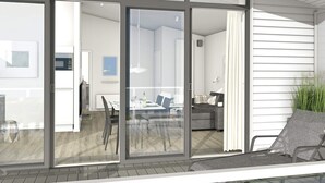 A modern interior with a dining area, kitchen, and living space visible through large glass doors. - Holiday Home in Wendtorf (Wendtorf)