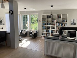 Relax in this serene space with a book, unwind in comfortable armchairs, and enjoy entertainment options.
