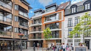 A modern building with multiple floors, large windows, and a mix of brick and glass facades. - Beautiful Apartment in the Center (Blankenberge)