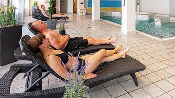 Relax by the pool in this serene space, featuring a large pool and comfortable lounge chairs.