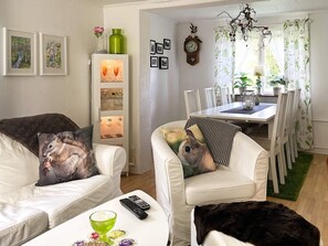 Relax in style with a sofa, coffee table, and dining area, perfect for unwinding and enjoying the view.