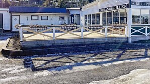 A waterfront restaurant named Strandgrillen with outdoor seating and a view of the water. - 6 Person Holiday Home in Vikbolandet-by Traum (Vikbolandet)