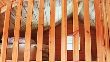 A wooden ceiling with a slatted design, likely part of a building's interior structure.