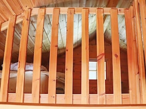 A wooden ceiling with a slatted design, likely part of a building's interior structure.
